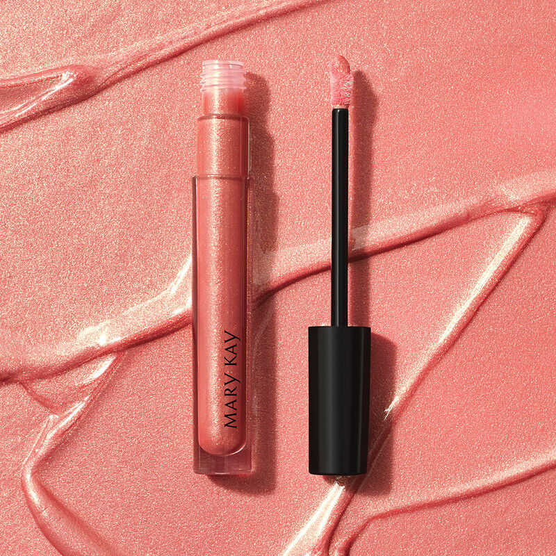 Open tube of Mary Kay Unlimited Lip Gloss in shade Fancy Nancy against accompanying shade rub.