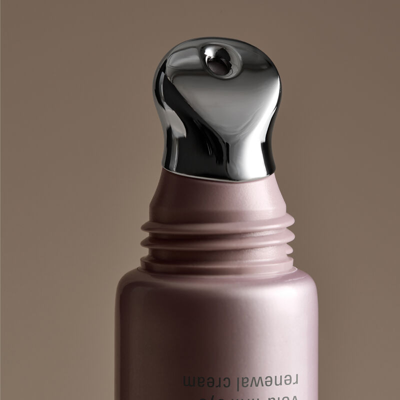 Close-up of Eye Renewal Cream applicator against beige background with shadows