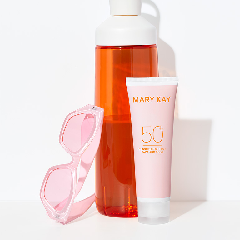 Mary Kay Sunscreen Broad Spectrum SPF 50 with orange water bottle and pink sunglasses for summer essentials.